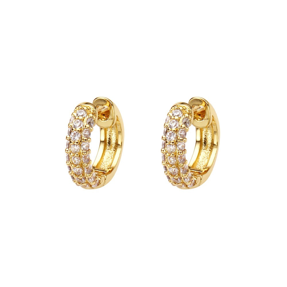 Gold hoop earrings with clear gemstones on a white background