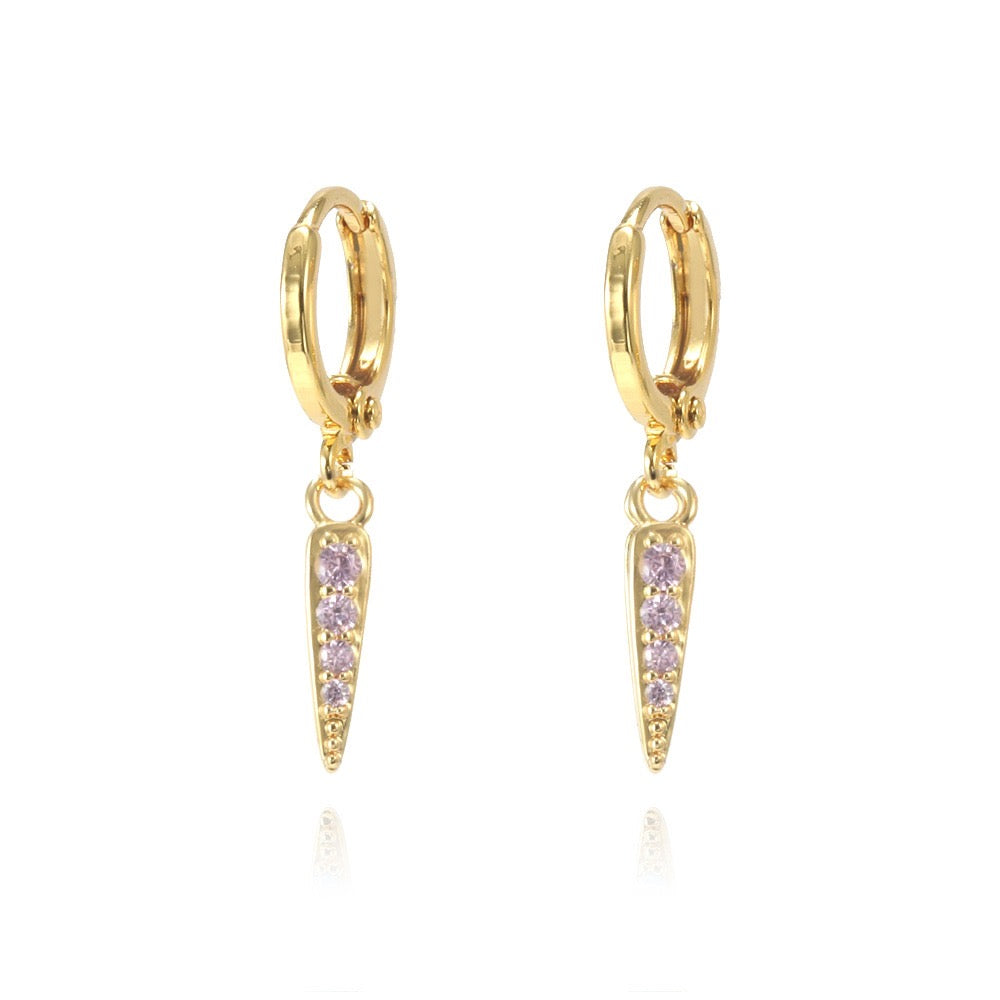Gold hoop earrings with pink gemstones on a white background