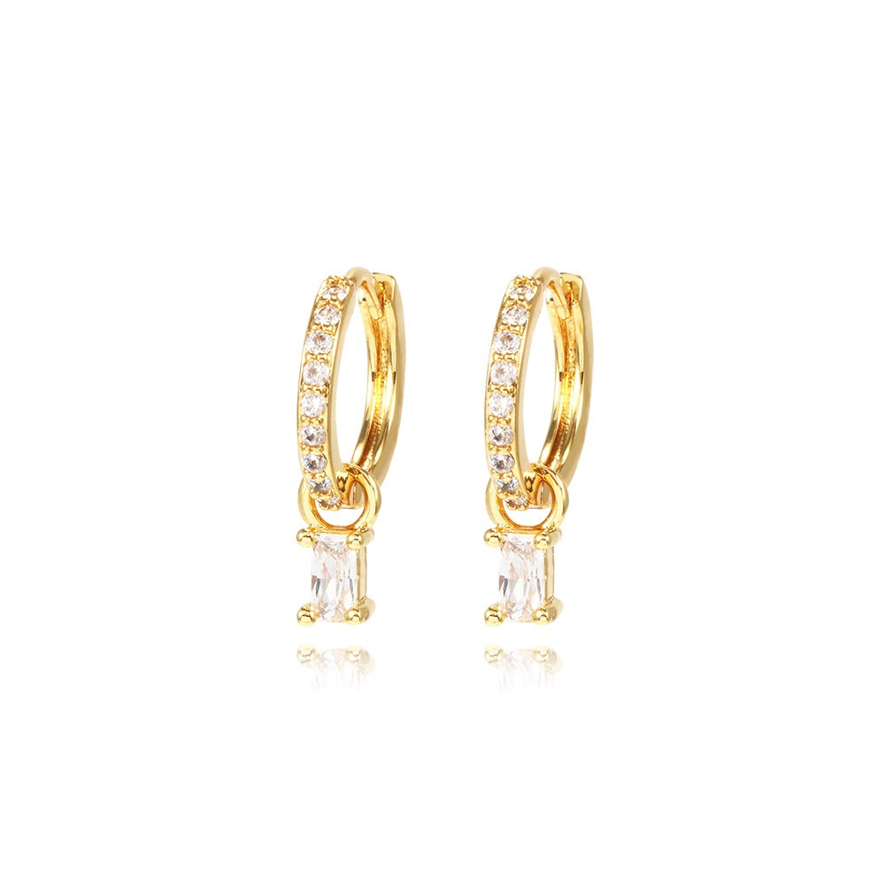 Gold hoop earrings with clear gemstones on a white background