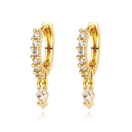 Gold hoop earrings with diamond-like stones on a white background