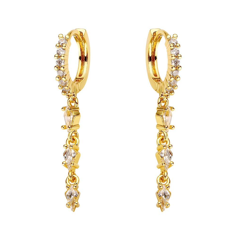 Gold hoop earrings with small diamonds on a white background