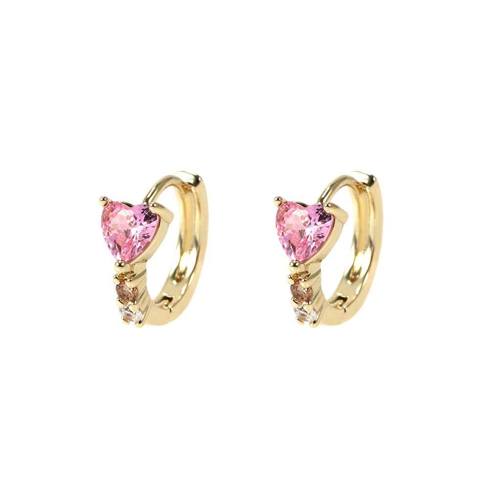 Gold hoop earrings with pink heart-shaped gemstones on a white background