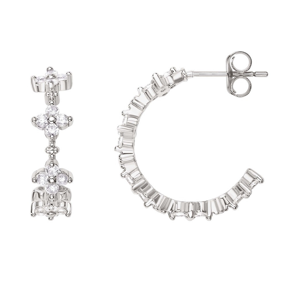Pair of silver hoop earrings with clear gemstones on a white background