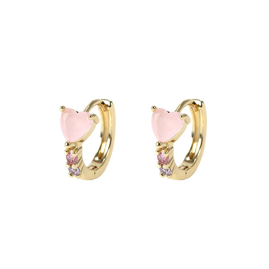 Gold hoop earrings with pink heart-shaped stones on a white background